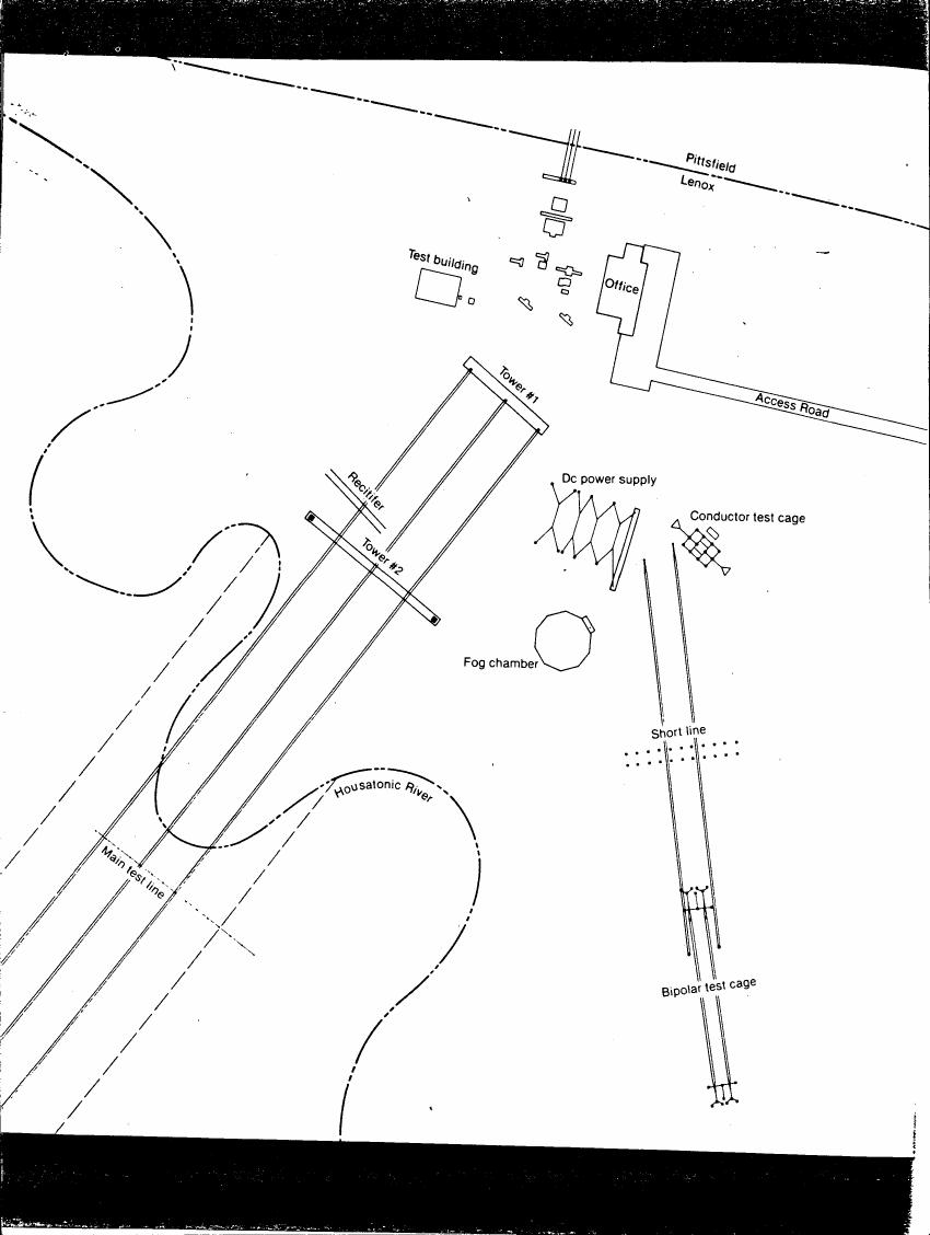 AI-described figure: A detailed layout diagram showing various components and structures related to a test facility, including towers, power supplies, and test cages.